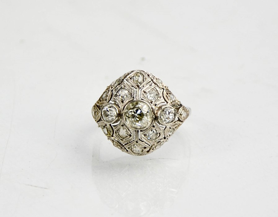 An Art Deco diamond and platinum ring, the central diamond approximately 0.8cts, flanked by two - Image 3 of 8