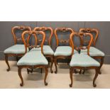 A set of Victorian rosewood balloon back chairs raised on cabriole legs covered in pale blue