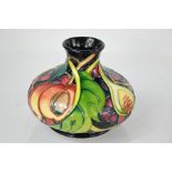 A Moorcroft vase in the fig & fruit pattern, painted and impressed with factory marks, 9cm high.