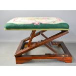 A tapestry top folding footstool / table rest, ratcheted height adjustable.
