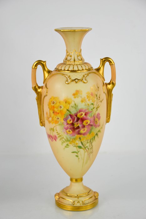 A Royal Worcester blush ivory vase, with twin handles and painted with flowers, 26cm high.