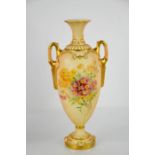 A Royal Worcester blush ivory vase, with twin handles and painted with flowers, 26cm high.