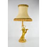 A Royal Worcester table lamp in the form of a classical lady in gilded robes, standing beside a