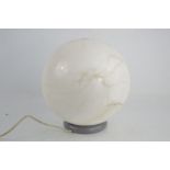 A mid-century designer table lamp, with a marble spherical shade.