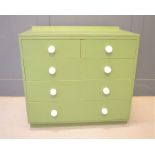 A pine chest of drawers, painted green, with two short over three long drawers, ceramic knobs.