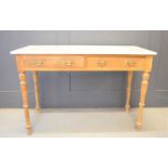 A Victorian marble top table with two drawers and raised on turned legs.