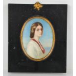 A 19th century watercolour portrait of a young woman in an oval frame, 11 by 8cm.