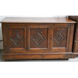 A late 18th century oak mule chest (with later added mirror back), the three panel front carved with