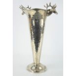 A silver plated vase, with stag heads modelled to the rim.