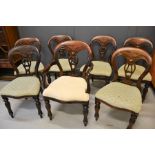 A set of seven antique mahogany chairs with upholstered seats.