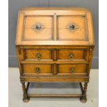 An oak 1950s bureau, with fall front, and two drawers.