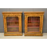 A pair of 19th century marquetry pier cabinets, the glazed doors enclosing a shelved interior.