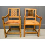 A pair of Robert Thompson 'Mouseman' arm chairs with trademark carved mice to the legs, lattice