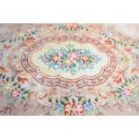 A large Chinese rug, cream ground with floral pattern. 555cm by 373cm
