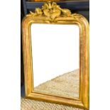 An early 19th century giltwood wall mirror, with crested top, and incised decoration to the