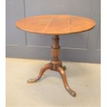 A Georgian oak tilt drop tripod table, 73cms tall x 79cms diameter