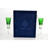 A 20th century pair of Faberge champagne flutes, in green, with the original presentation case, 23cm