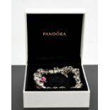 A Pandora bracelet with nineteen silver charms, in the original presentation box.