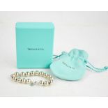 A silver Tiffany & Co. bracelet, composed of silver beads, with original box and draw string bag.