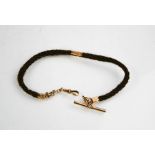 A Victorian 9ct gold and hair mourning chain, approximately 5g.