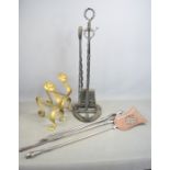 A pair of antique brass andirons, wrought iron fireside companion set