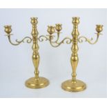 A pair of brass two arm scroll candelabra