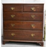 A 19th century oak chest of drawers, with two over three long graduated drawers, raised on bracket
