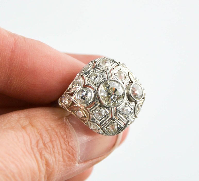 An Art Deco diamond and platinum ring, the central diamond approximately 0.8cts, flanked by two - Image 6 of 8