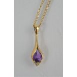 A 9ct gold and amethyst pendant necklace. 2.1g