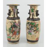 A pair of 19th century stoneware Chinese vases decorated with a battle scene and salamanders