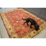 A 20th century Persian rug with red ground, with stylized trees and motifs, 217cms x 300cms
