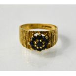 A 9ct gold and sapphire flower head and 'bark' ring, size L, 3g.