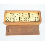 A Victorian bone and ebony wood domino set