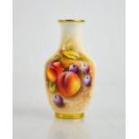 A Royal Worcester vase painted with peaches and blueberries, signed Roberts, 12cm high.