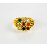 A gold (unmarked) ring set with pearl, coral, emerald, sapphire, moonstone, diamond, ruby and topaz,