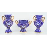 A ceramic blue ground garniture of vases.
