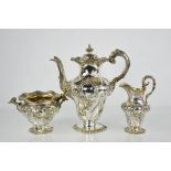 A fine William IV chased three piece tea service with raised floral leaf decoration, with gilt