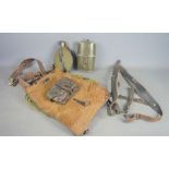 A WWII German fur covered leather canvas pack dated 1942 together with an ammo pouch, Y-strap, water