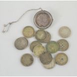 A group of silver threepenny coins together with a George III coin brooch