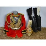 A Household cavalry officers helmet together with a musicians jacket and other ranks boot