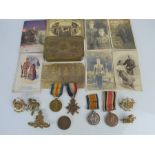 A WWI medal group to Sapper E.Y Danby together with a group of cap badges, photographs and a