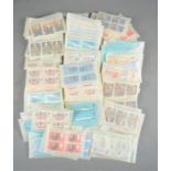 A collection of British stamps from the 1960s in individual packets of a hundred, approx 4000 plus