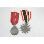 A German eastern front medal together with a merit cross medal