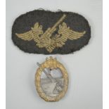 A German coastal artillery badge together with a WWII cloth example