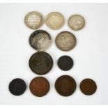 A group of coins to include a George III coin, a 1797 Anglesee penny, George III 1804 dollar, 1819