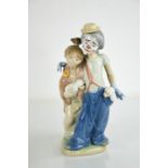 A Lladro porcelain clown and girls with puppies, 7686, 23cm high.