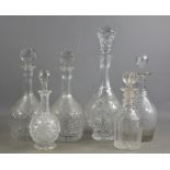 A group of six cut glass decanters of various style and form.