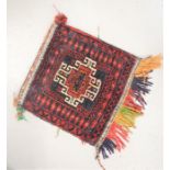 An Afganistan Belouch bag with red ground, 1ft2 by 1ft2ins, together with another with brown