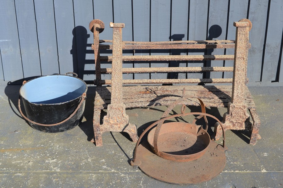 A cast iron fire grate and andirons