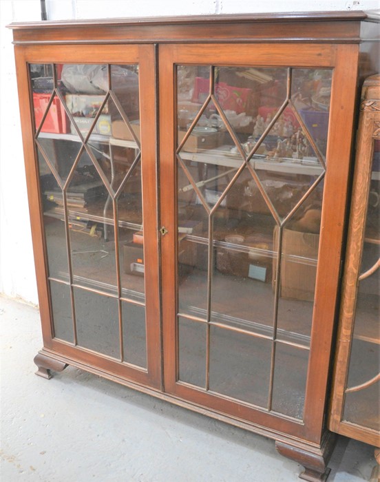 A 19th century mahogany display cabinet with glazed doors, 138cm by 118cm by 37cm